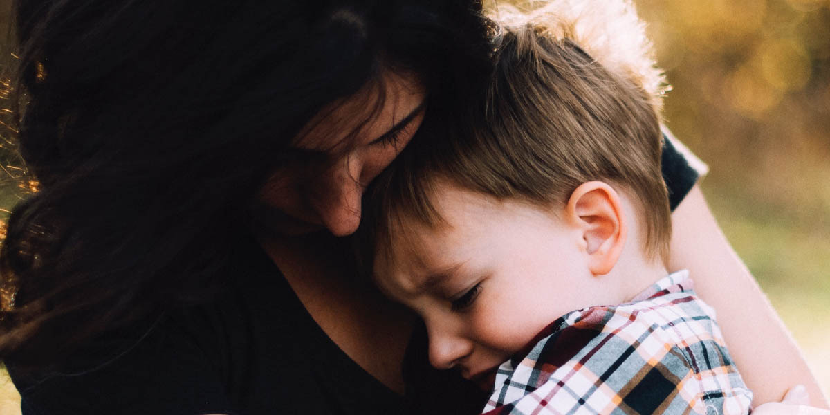 Woman embracing child